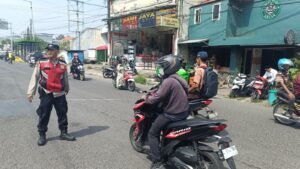 Polsek Krian Bantu Jamaah dengan Humanis Menyebrang Jalan Menuju Masjid Jelang Sholat Jumat